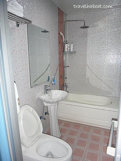 Clean bathroom with bathtub and shower. Basic toiletries also provided.
