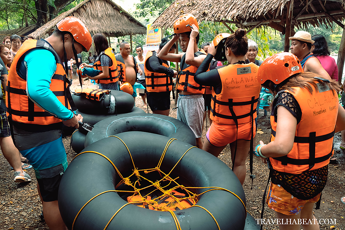 Preparing with the river tubing equipment: helmet, life vest, and tire tube.